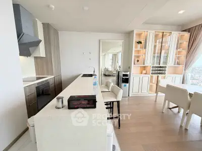 Luxurious modern kitchen with open layout and stunning city view, featuring sleek cabinetry and elegant dining area.