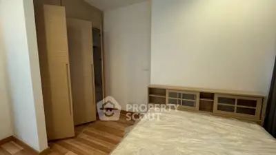 Cozy bedroom with wooden flooring and built-in wardrobe