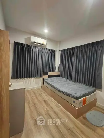 Cozy bedroom with modern decor and ample natural light