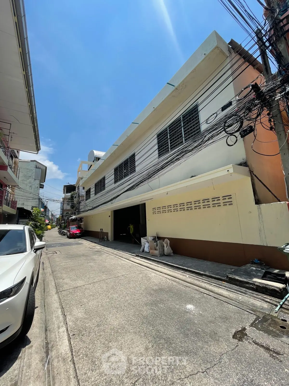 Spacious urban building with potential for commercial or residential use, featuring ample street access.