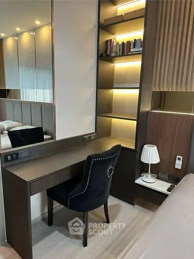 Modern bedroom with stylish desk and built-in shelves, perfect for a cozy workspace.