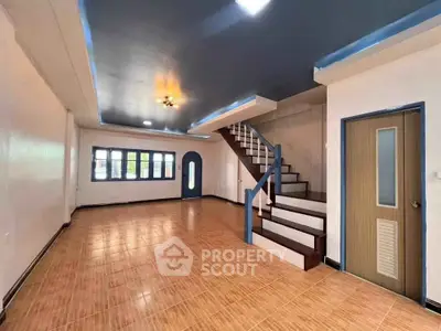 Spacious living room with modern staircase and stylish ceiling design