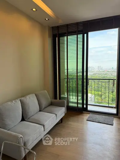 Modern living room with a stunning city view and cozy sofa, perfect for relaxation.