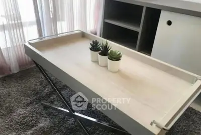 Modern interior with stylish table and decorative plants, enhancing the room's contemporary appeal.