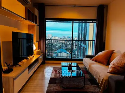 Modern living room with city view, stylish furniture, and large window for natural light.