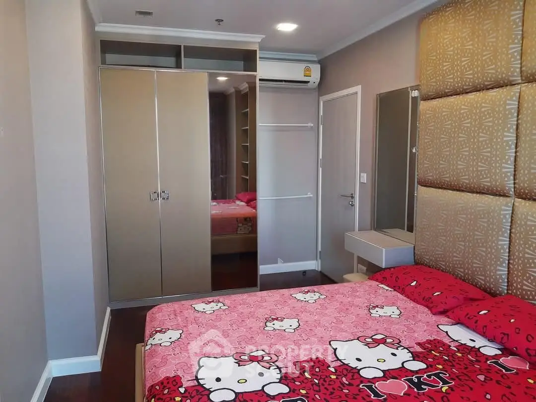 Charming bedroom with stylish decor and ample closet space in modern apartment.