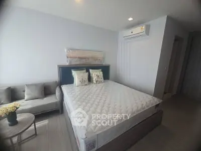 Modern bedroom with stylish decor and air conditioning in a contemporary apartment.
