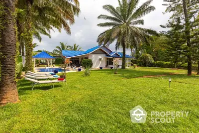 Luxurious villa with pool and lush garden, perfect for serene living in tropical paradise.