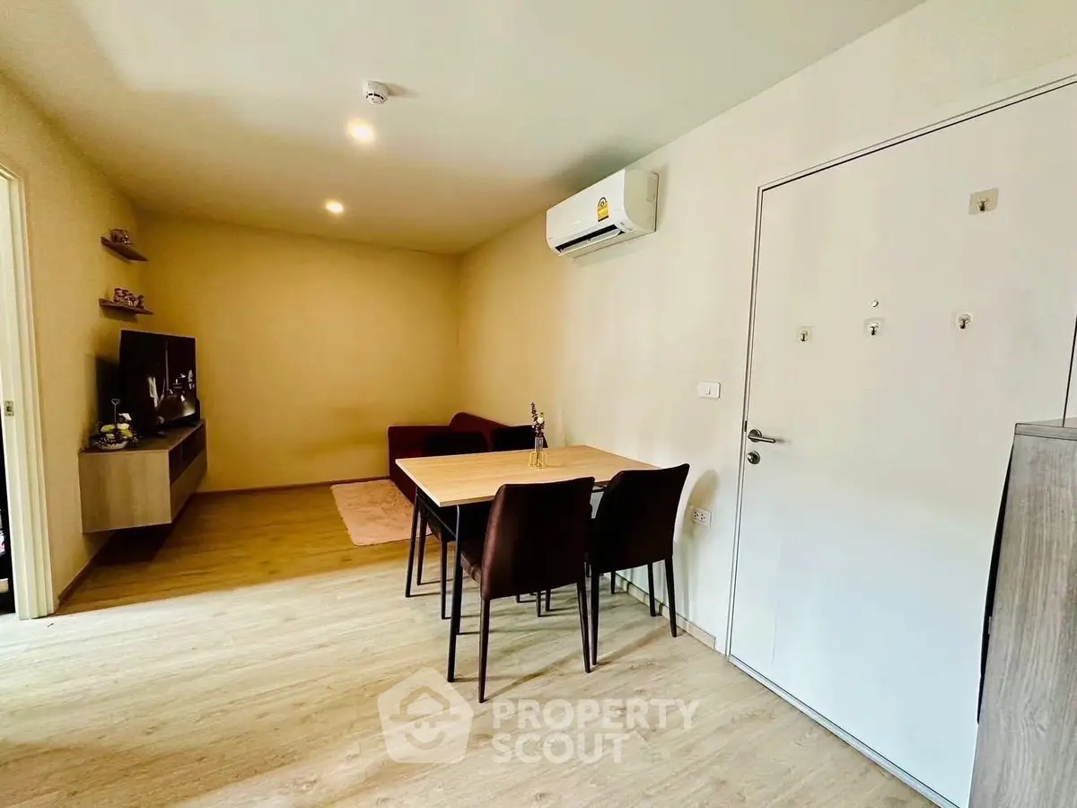 Modern living room with dining area and air conditioning in a cozy apartment.