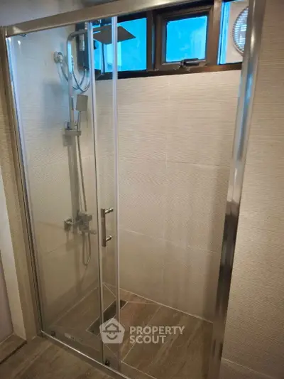 Modern bathroom shower with glass door and sleek fixtures