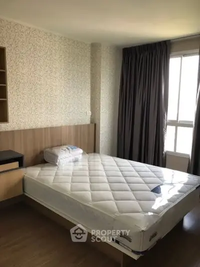 Cozy bedroom with natural light and modern furnishings, perfect for relaxation.