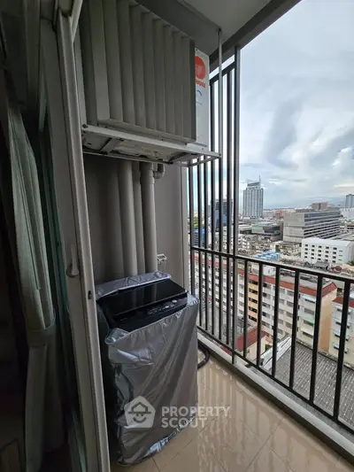 High-rise balcony with city view and air conditioning unit, perfect for urban living.