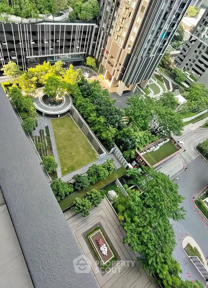 Stunning aerial view of modern building with lush green gardens and pathways