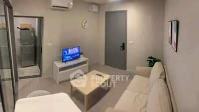 Cozy living room with modern decor and air conditioning, perfect for relaxation.