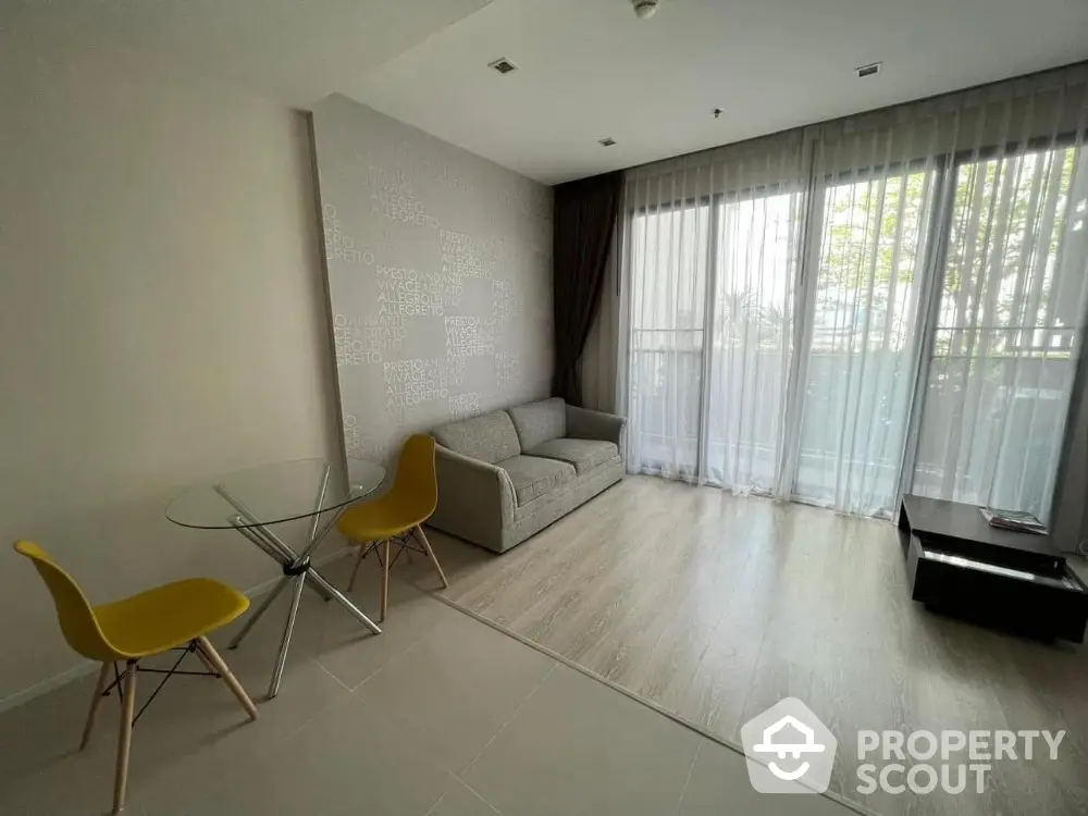 Modern living room with floor-to-ceiling windows and minimalist furniture