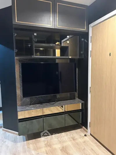 Modern living room with sleek TV unit and stylish storage cabinets.