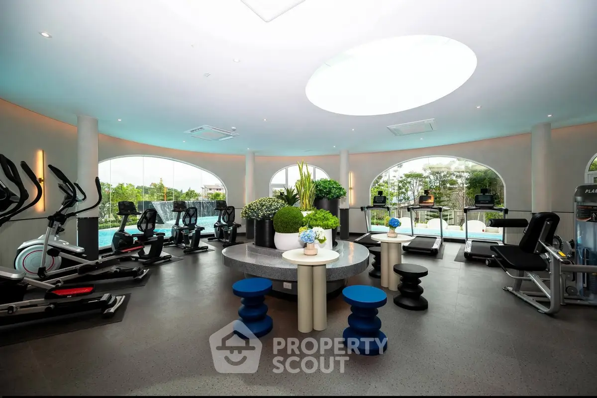 Luxurious gym with modern equipment and scenic views, perfect for fitness enthusiasts.