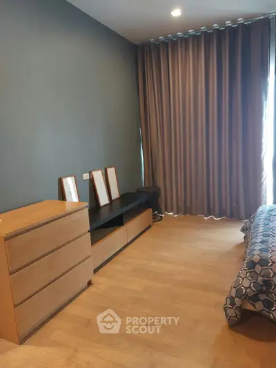 Modern bedroom with wooden flooring and stylish decor