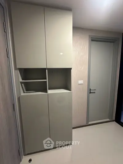Modern storage cabinet in a sleek hallway with minimalist design.