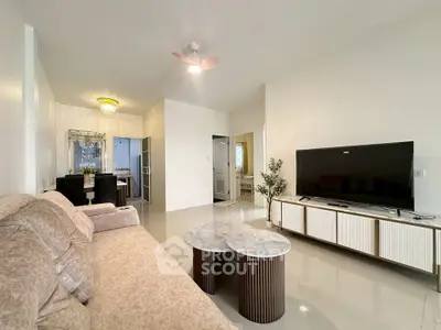 Spacious modern living room with elegant decor and large TV