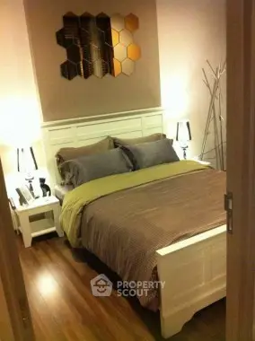 Cozy bedroom with stylish decor and wooden flooring in modern apartment.