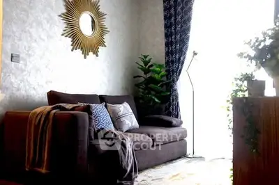 Cozy living room with stylish sofa, decorative mirror, and lush greenery.