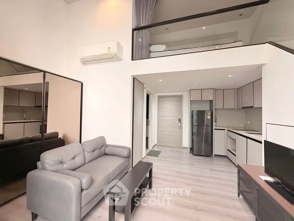Modern loft apartment with open layout, stylish furniture, and sleek kitchen design.