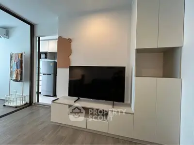 Modern living room with sleek TV unit and open balcony view