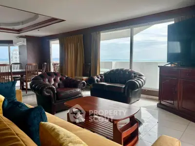 Luxurious living room with leather sofas and stunning ocean view, perfect for relaxation and entertaining.
