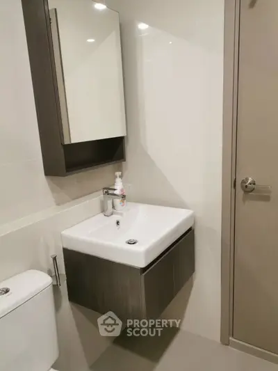 Modern bathroom with sleek sink and mirror cabinet