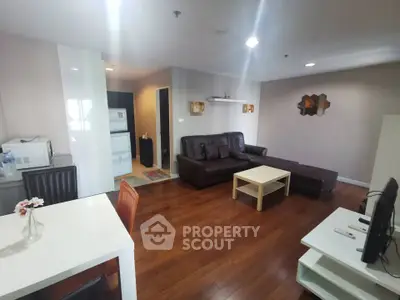 Spacious living room with modern furniture and open kitchen layout