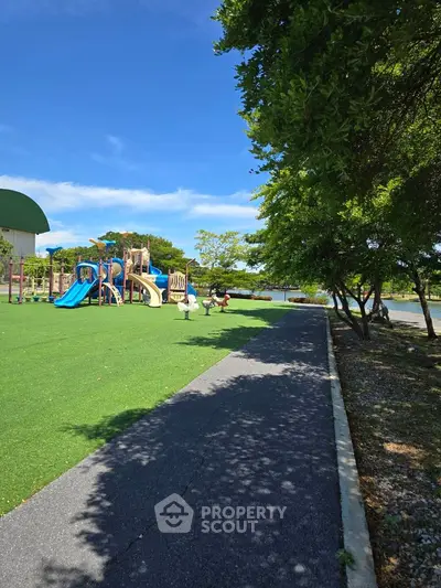 Charming playground with modern equipment in a lush green park setting, perfect for family-friendly communities.