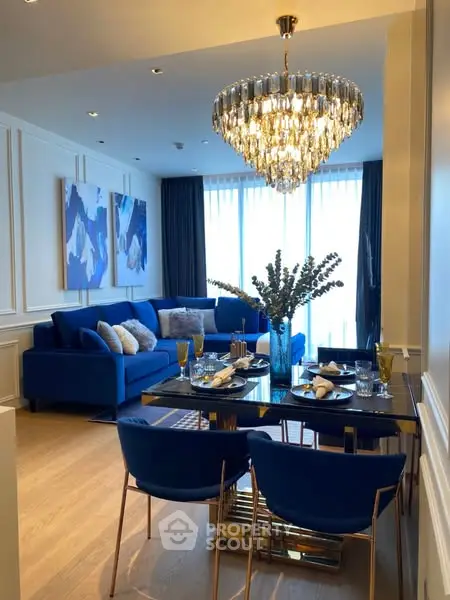 Luxurious living room with elegant chandelier and modern blue decor
