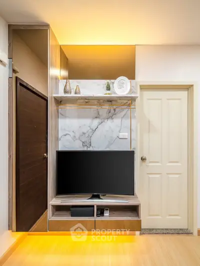 Modern living room with stylish TV unit and marble accents