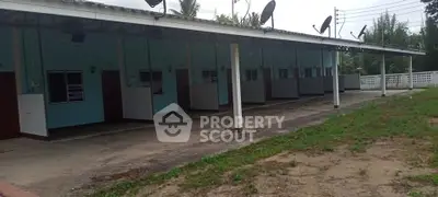 Row of single-story units with satellite dishes and covered walkway