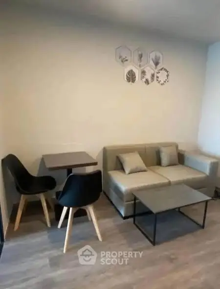 Modern living room with stylish furniture and wall decor, perfect for cozy gatherings.