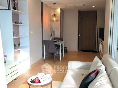 Modern living room with cozy sofa, dining area, and stylish decor in a bright apartment.