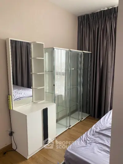 Cozy bedroom with glass display cabinet and elegant curtains