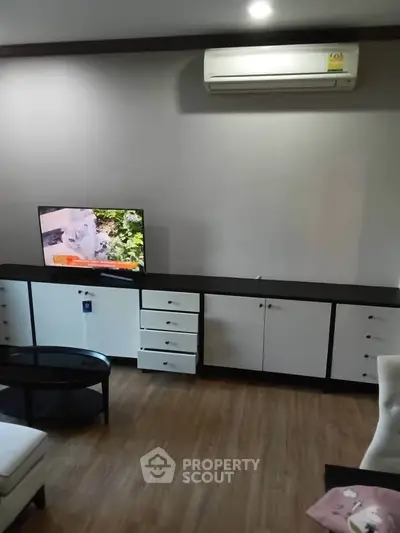 Modern living room with sleek furniture and air conditioning, perfect for comfortable living.