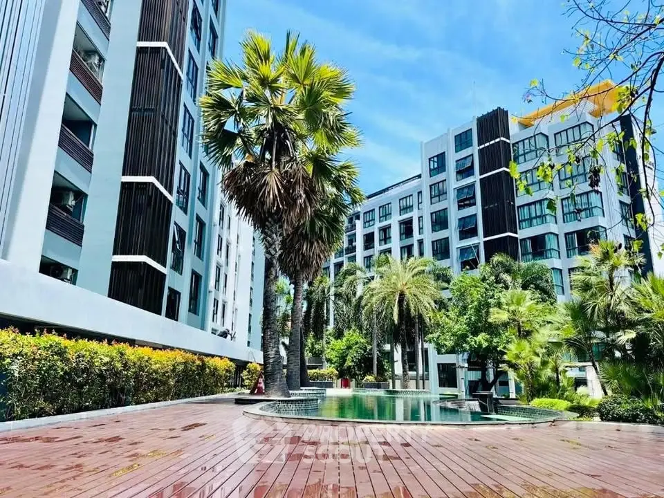 Luxurious condominium with stunning pool and lush greenery, perfect for modern living.