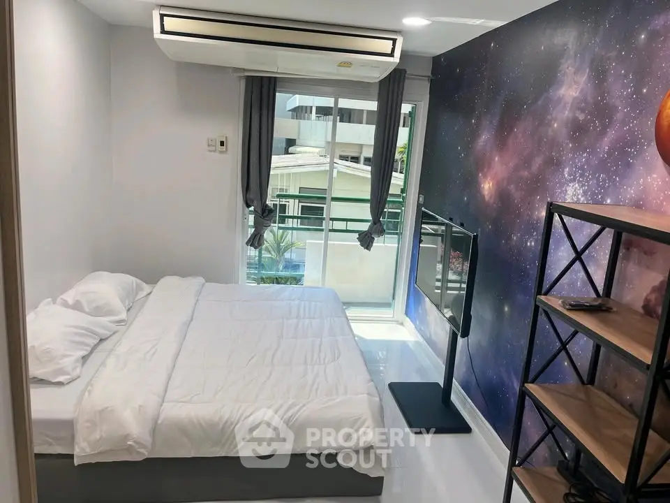 Modern bedroom with galaxy-themed wall, large window, and sleek shelving unit.