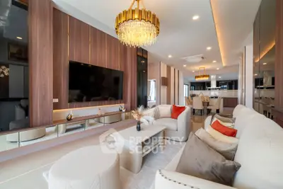 Luxurious modern living room with elegant chandelier and open kitchen layout