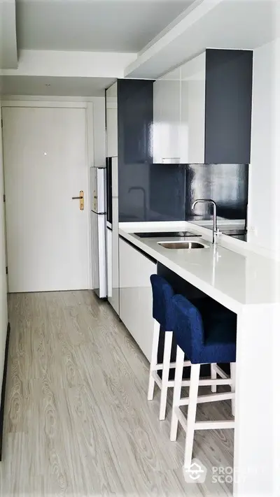 Modern compact kitchen with sleek design and breakfast bar seating