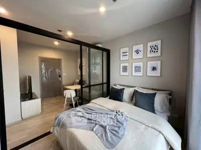Modern bedroom with stylish decor and glass partition for added elegance.