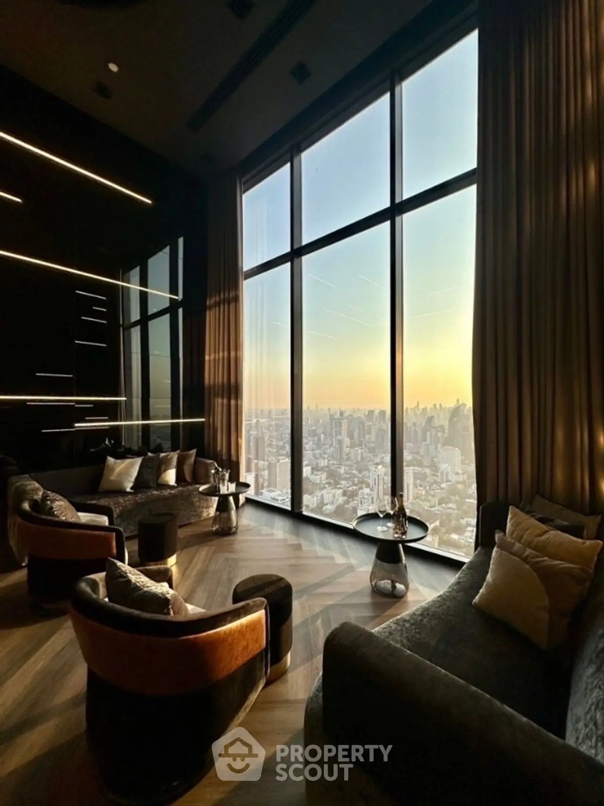 Luxurious high-rise living room with panoramic city views and elegant decor.