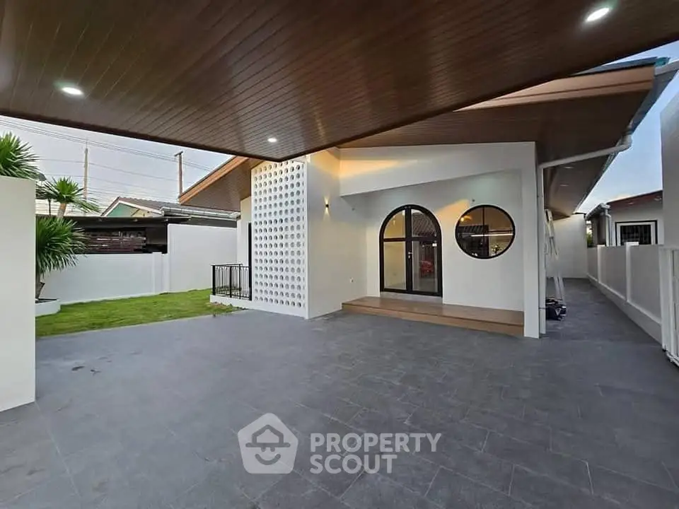 Modern home exterior with sleek design and spacious patio area
