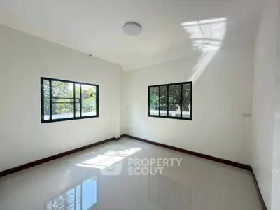 Bright empty room with large windows and glossy tiled floor, perfect for customization.