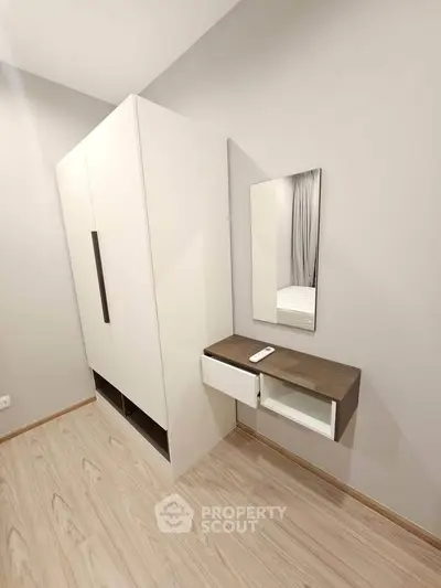 Modern bedroom with sleek wardrobe and minimalist dressing table