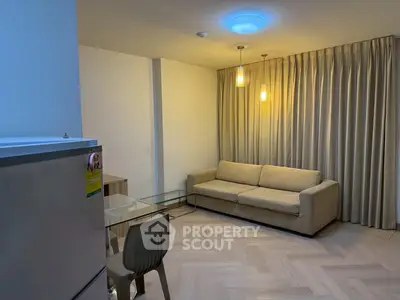 Cozy living room with modern sofa and glass coffee table, perfect for relaxation.