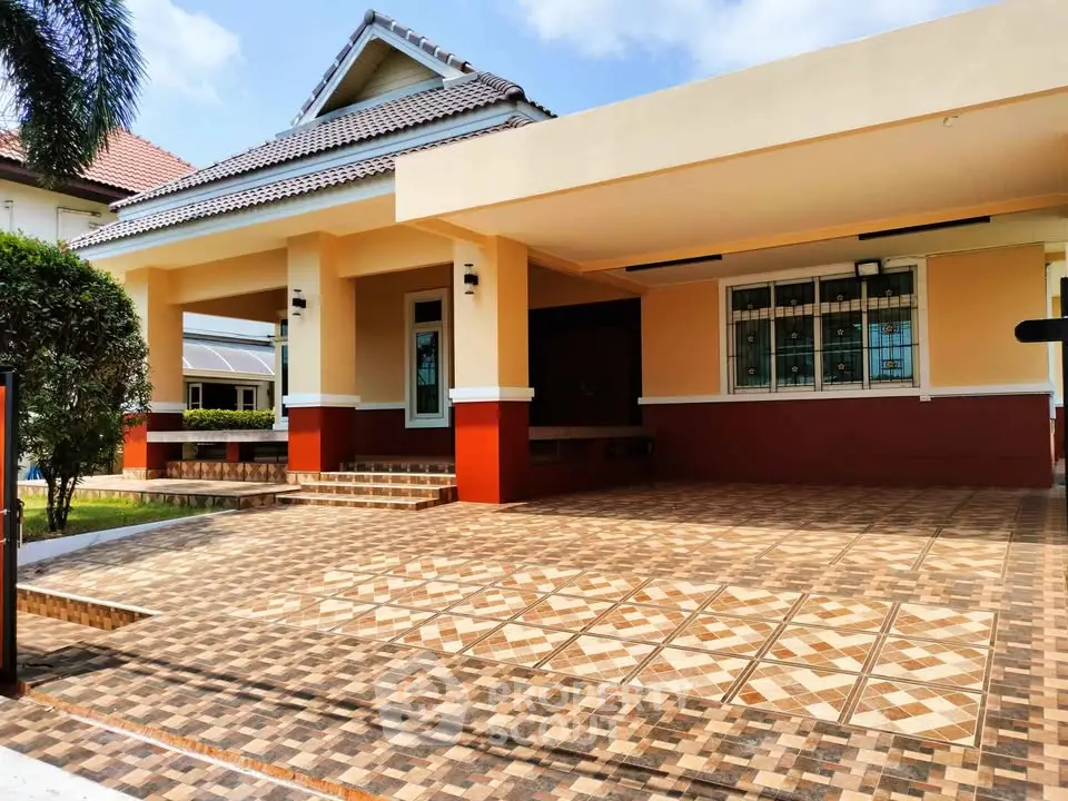 Charming single-story home with spacious tiled driveway and inviting entrance.